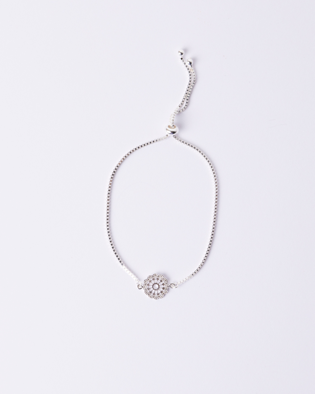 Adjustable Silver bracelet with a decorative clasp and small daisy charm.
